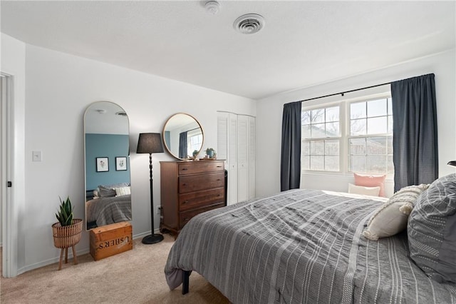 bedroom featuring baseboards, visible vents, a closet, and light colored carpet