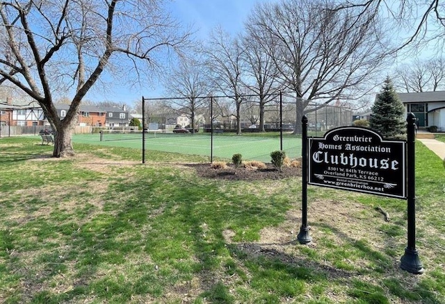 view of home's community featuring a yard, a tennis court, and fence