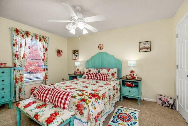 carpeted bedroom featuring a ceiling fan and baseboards