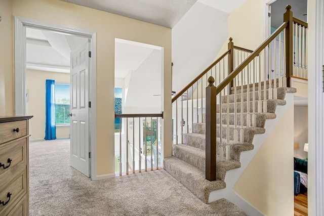 stairway featuring carpet and baseboards