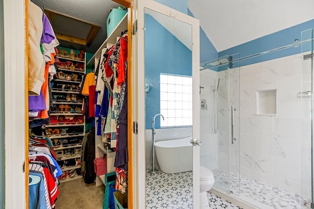 full bath featuring a soaking tub, a shower stall, and a walk in closet