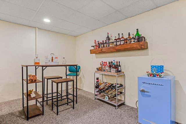 bar with a paneled ceiling and carpet flooring