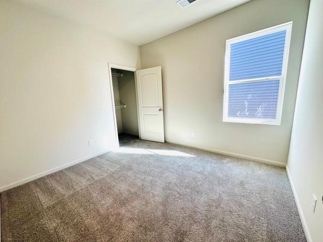 unfurnished bedroom with baseboards and carpet flooring