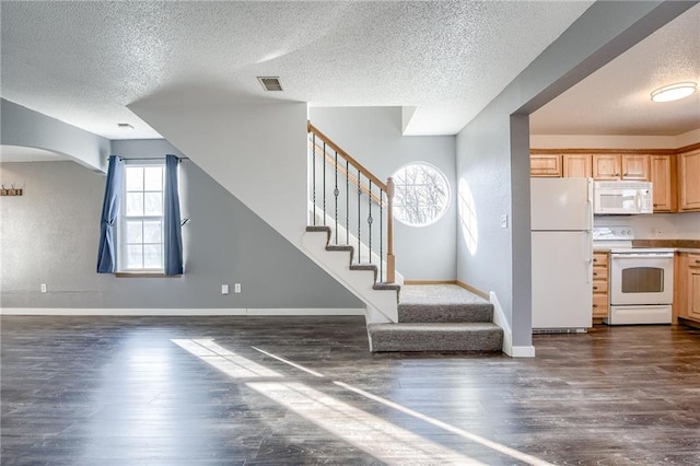 kitchen with white appliances, visible vents, baseboards, open floor plan, and dark wood finished floors