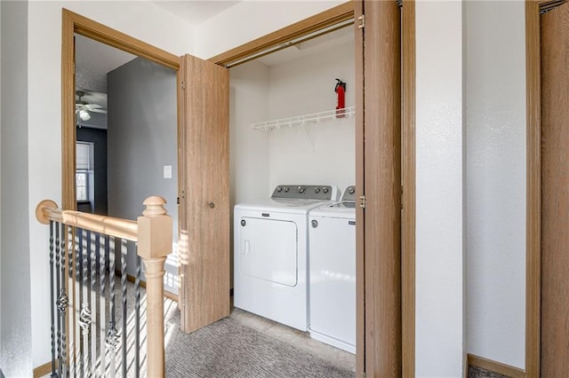 laundry area featuring laundry area, washer and clothes dryer, and light colored carpet