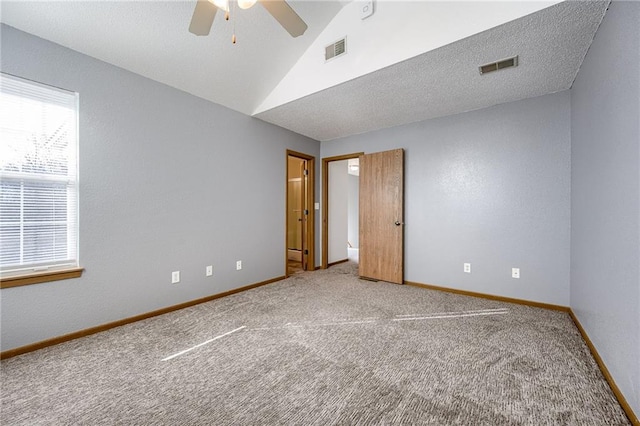 interior space featuring vaulted ceiling, visible vents, and baseboards