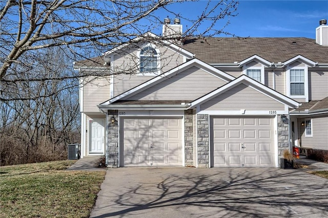 traditional-style house featuring aphalt driveway, stone siding, central AC, and a chimney