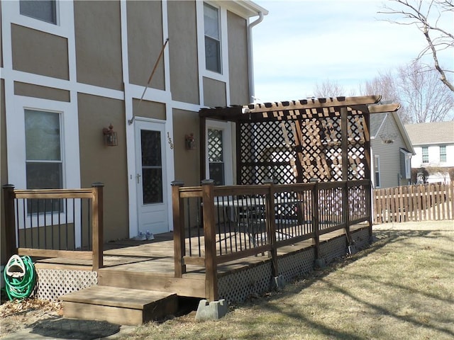 wooden deck with a lawn and fence