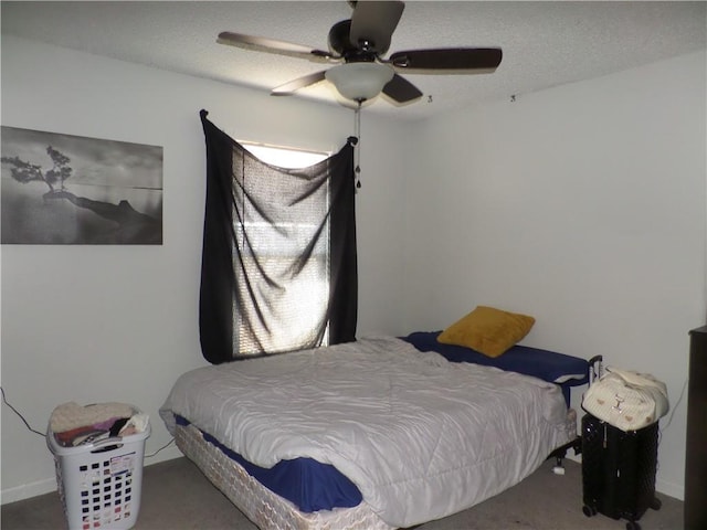 carpeted bedroom with a textured ceiling and a ceiling fan