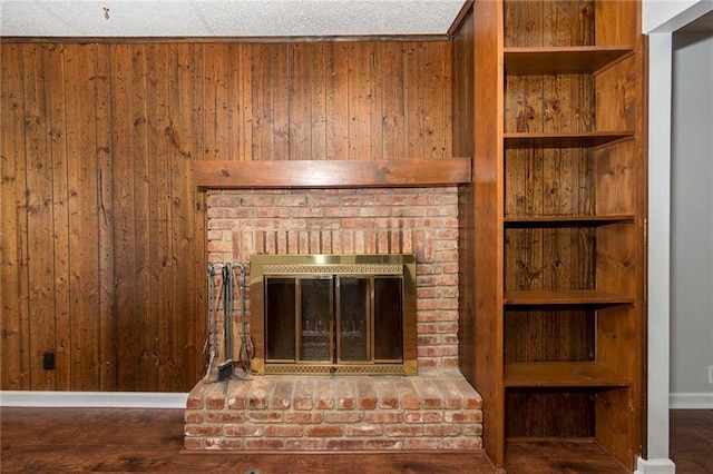 details with wood finished floors, a brick fireplace, and wood walls