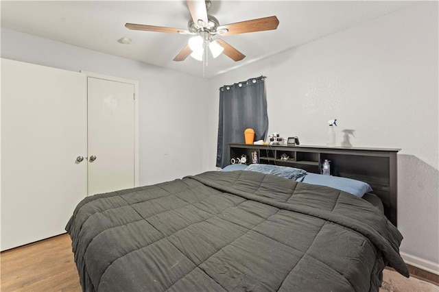 bedroom with wood finished floors and ceiling fan