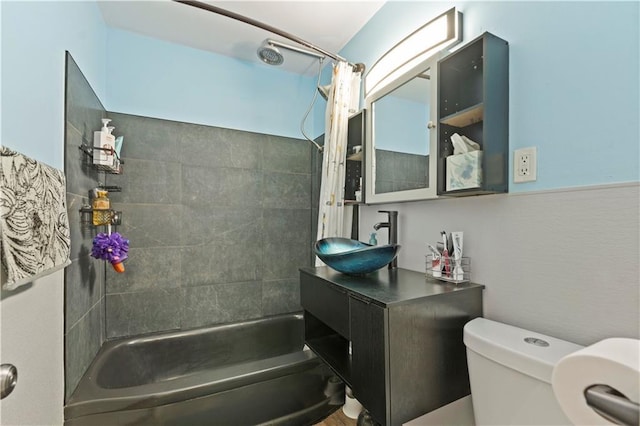 full bathroom with a sink, toilet, and shower / bath combo