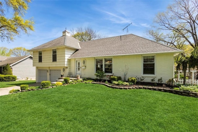 7345 Booth St, Prairie Village, KS 66208 - split level home with an attached garage, a chimney, a front yard, and roof with shingles