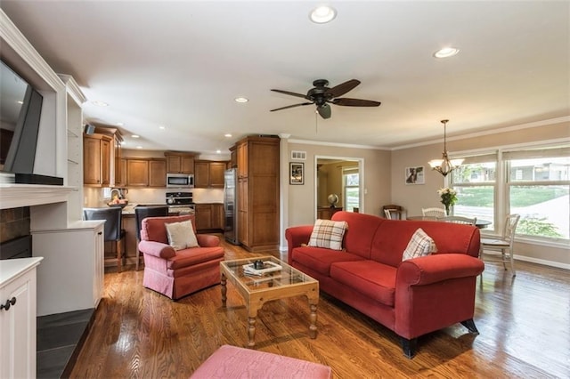 7345 Booth St, Prairie Village, KS 66208 - living room with ceiling fan with notable chandelier, plenty of natural light, wood finished floors, and crown molding
