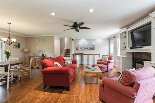 7345 Booth St, Prairie Village, KS 66208 - living room with wood finished floors, visible vents, crown molding, a fireplace, and ceiling fan with notable chandelier