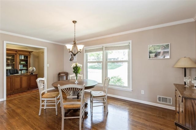 7345 Booth St, Prairie Village, KS 66208 - dining room with baseboards, visible vents, a chandelier, wood finished floors, and crown molding