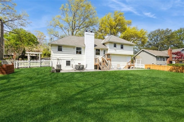 7345 Booth St, Prairie Village, KS 66208 - rear view of house featuring a patio area, a lawn, a fenced backyard, and a chimney