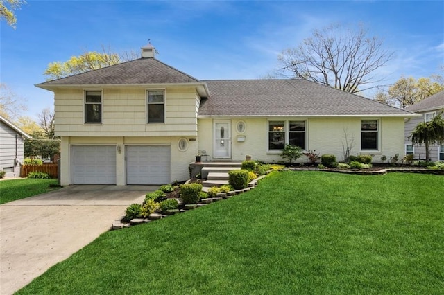 7345 Booth St, Prairie Village, KS 66208 - split level home with a chimney, an attached garage, concrete driveway, and a front yard