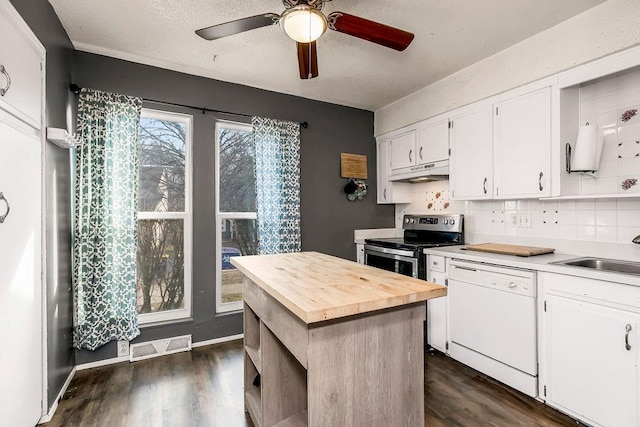 kitchen featuring stainless steel electric range oven, butcher block counters, white dishwasher, a sink, and under cabinet range hood