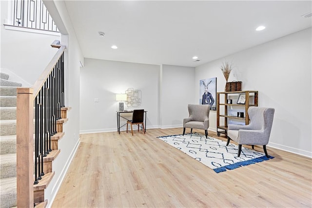 15026 W 129th Ter, Olathe, KS 66062 - sitting room with wood finished floors, stairs, and recessed lighting