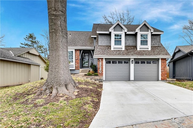 view of front of property featuring driveway, an attached garage, brick siding, and roof with shingles