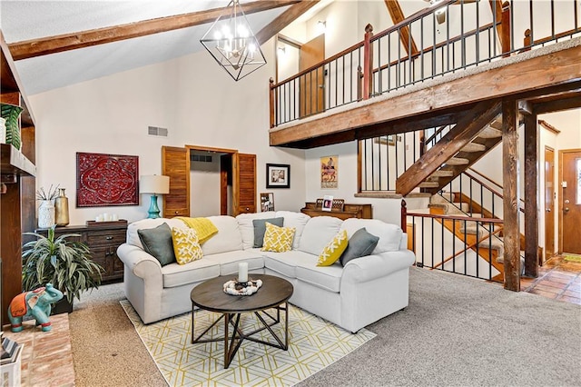 living area with an inviting chandelier, beam ceiling, visible vents, and carpet floors