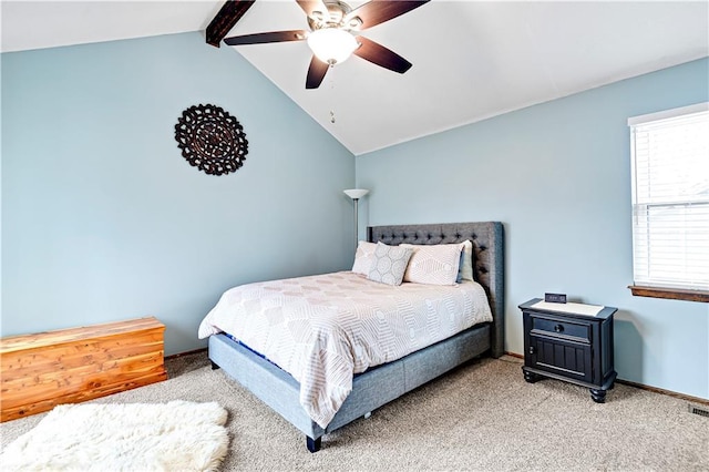 bedroom featuring light colored carpet, a ceiling fan, lofted ceiling with beams, and baseboards