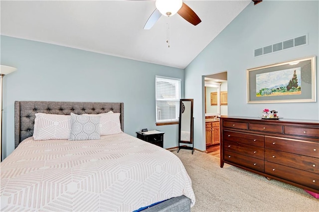 bedroom with a ceiling fan, baseboards, visible vents, ensuite bath, and light carpet