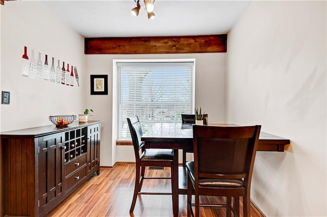 dining room with light wood-style flooring and baseboards