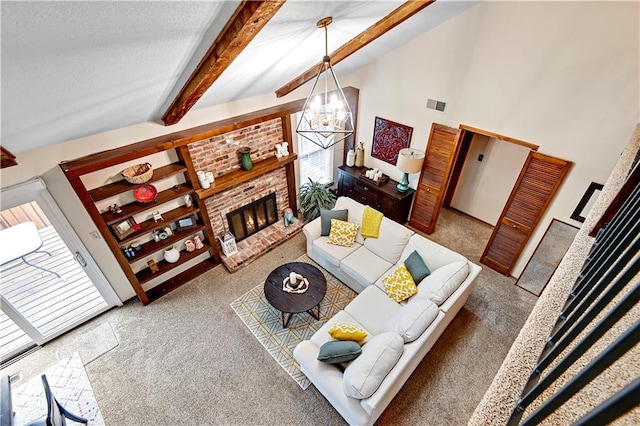 living area with a brick fireplace, carpet, beam ceiling, a notable chandelier, and a textured ceiling