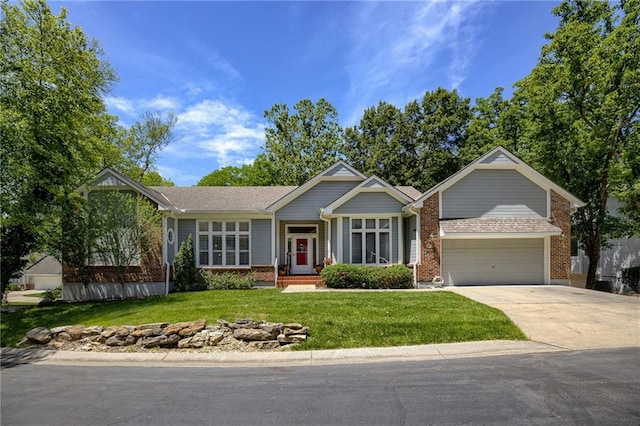 view of front of property featuring a garage, driveway, brick siding, and a front yard