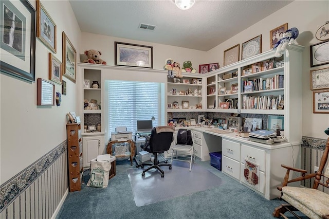 carpeted office with a wainscoted wall and visible vents