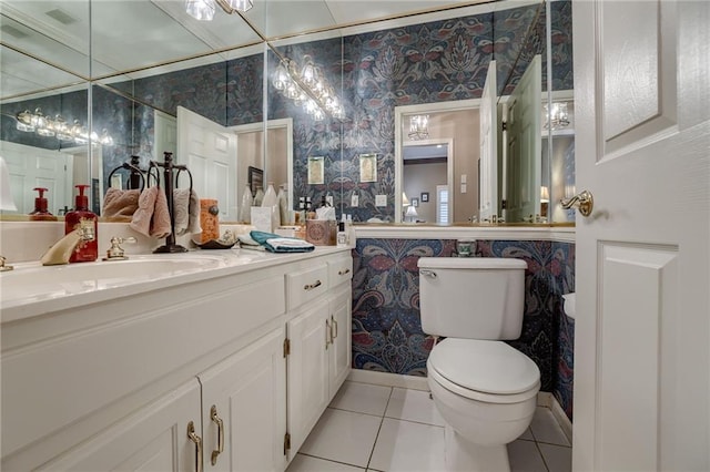 bathroom featuring toilet, wallpapered walls, vanity, and tile patterned floors