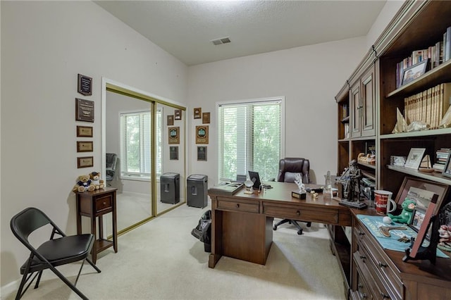 home office featuring visible vents and light colored carpet