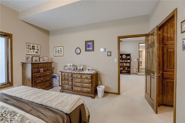 bedroom with light carpet and baseboards