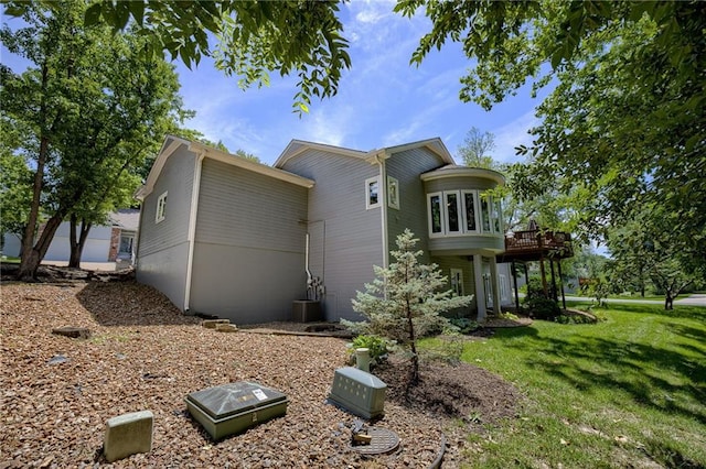 view of side of home featuring a lawn