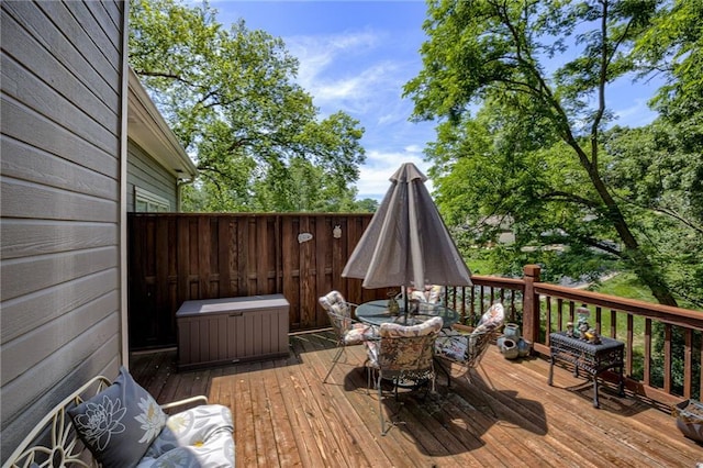 wooden terrace featuring outdoor dining area