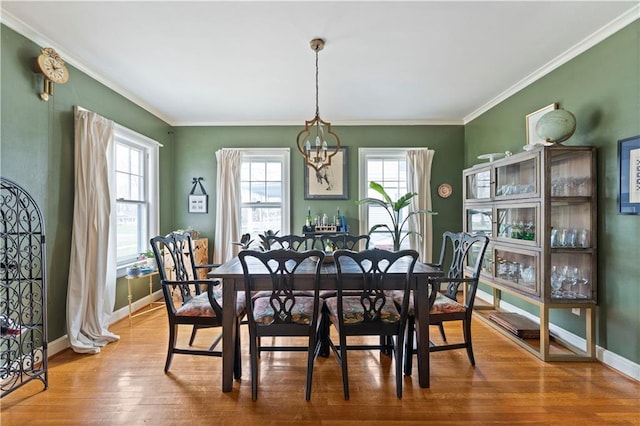 319 S Elm St, Ottawa, KS 66067 - dining room featuring a chandelier, wood finished floors, and crown molding