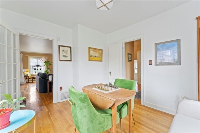 319 S Elm St, Ottawa, KS 66067 - dining space with light wood-style floors and baseboards