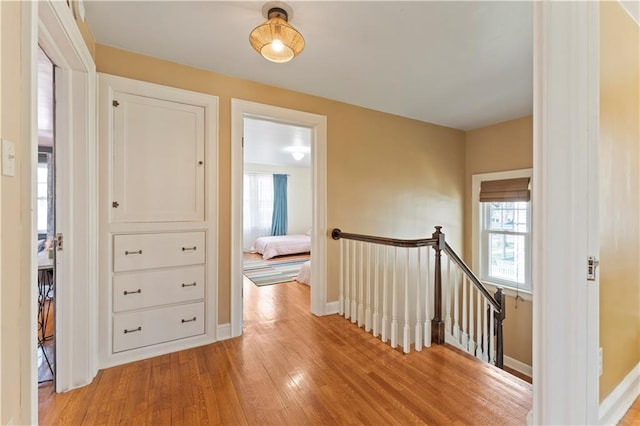319 S Elm St, Ottawa, KS 66067 - hall featuring an upstairs landing and light wood-style flooring