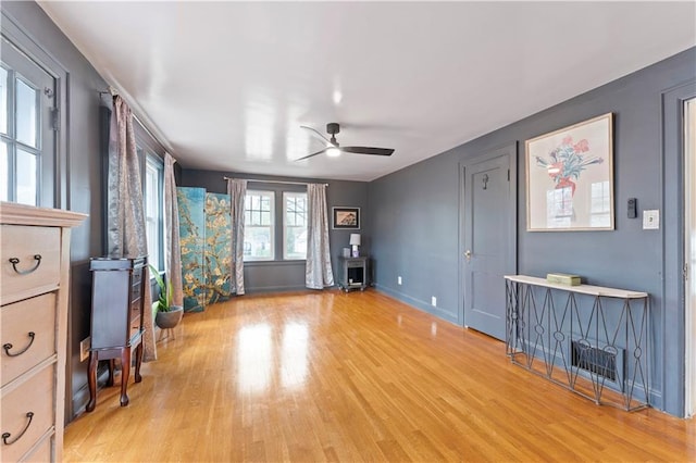 319 S Elm St, Ottawa, KS 66067 - unfurnished living room with a ceiling fan and light wood-style flooring