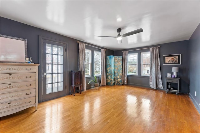 319 S Elm St, Ottawa, KS 66067 - empty room with wood finished floors, healthy amount of natural light, and a ceiling fan