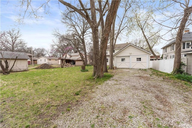 319 S Elm St, Ottawa, KS 66067 - view of yard featuring gravel driveway, an outbuilding, and a residential view