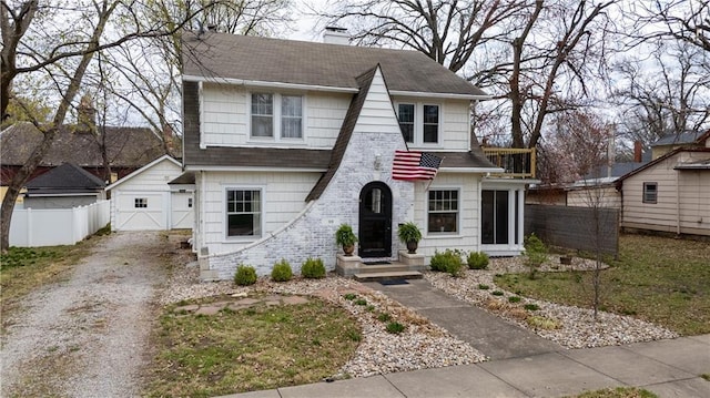319 S Elm St, Ottawa, KS 66067 - view of front facade with driveway, a chimney, a shingled roof, and a detached garage