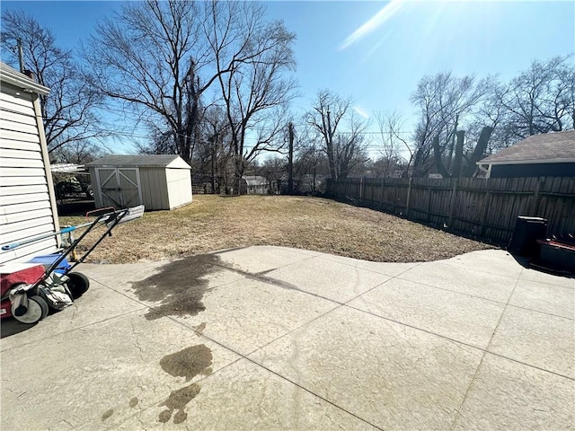 view of patio / terrace featuring a shed, an outdoor structure, and a fenced backyard