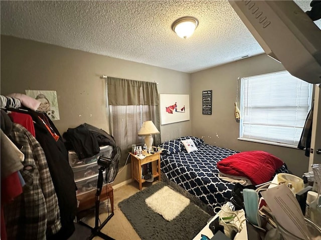 carpeted bedroom featuring visible vents and a textured ceiling