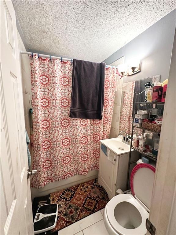 full bathroom featuring a textured ceiling, tile patterned flooring, toilet, vanity, and shower / bathtub combination with curtain