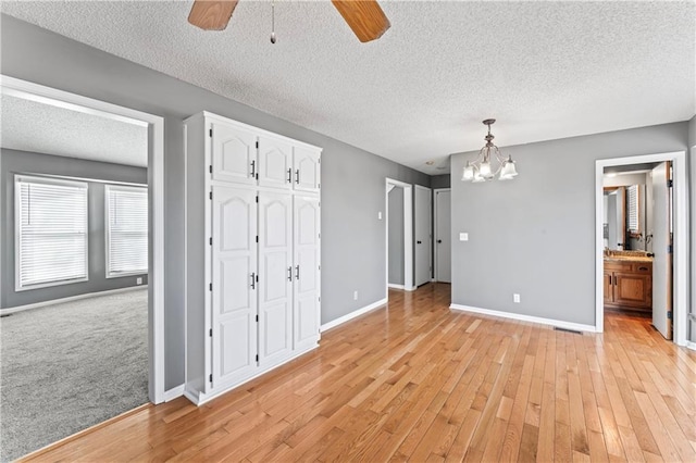 unfurnished dining area with light wood-style flooring and baseboards