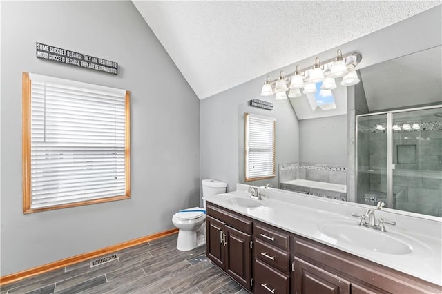 full bathroom featuring a sink, a shower stall, wood tiled floor, double vanity, and lofted ceiling with skylight