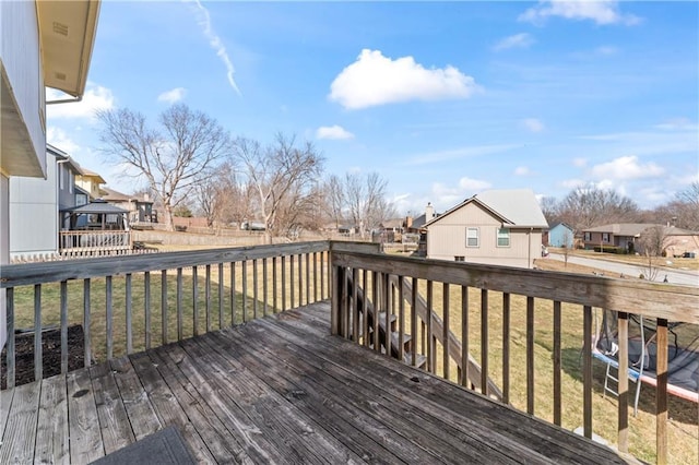 wooden deck with a lawn and a residential view